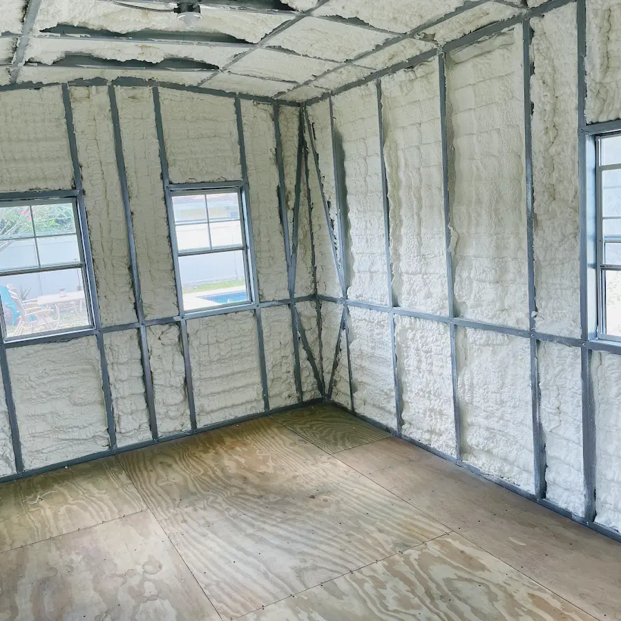 Closed-cell spray foam insulation applied to wall cavities in a residential project in Jan Phyl Village